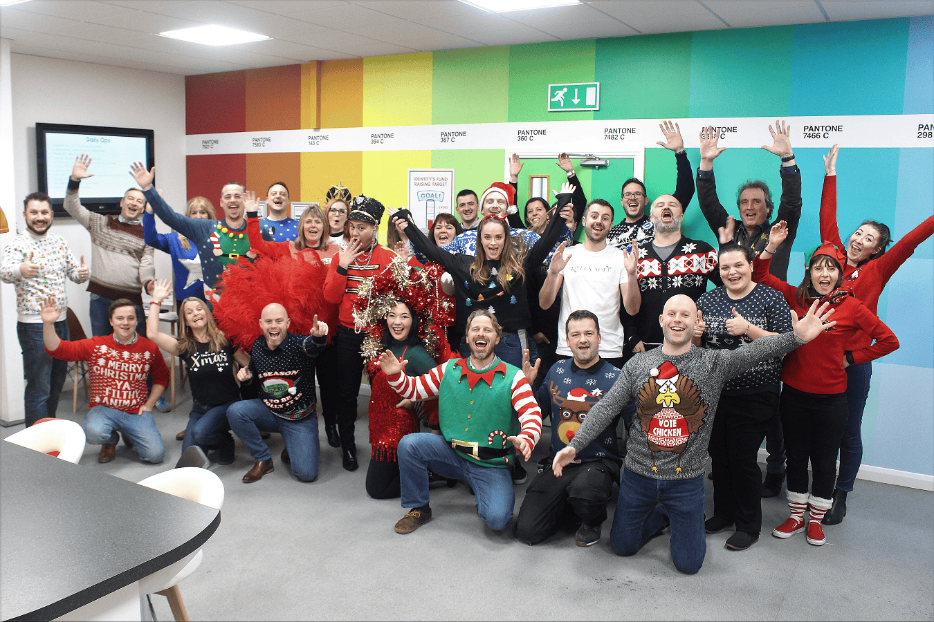 The Identity team pose in the office wearing Christmas jumpers